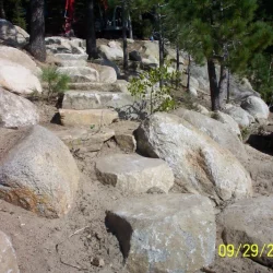 Stones on a dirt hill and large boulders